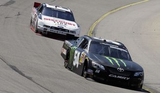 Sam Hornish Jr. leads Ryan Blaney, left, during the NASCAR Nationwide auto race, Sunday, May 18, 2014, at Iowa Speedway in Newton, Iowa. (AP Photo/Charlie Neibergall)