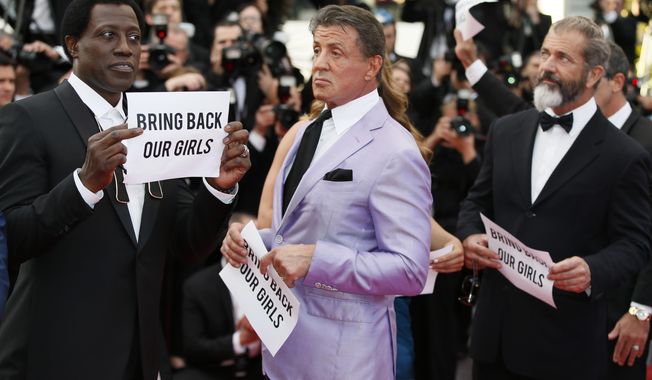 From left, the cast of The Expendables Wesley Snipes, Sylvester Stallone, and Mel Gibson hold up banners reading, &amp;quot;Bring back our girls&amp;quot;, part of a campaign calling for the release of nearly 300 abducted Nigerian schoolgirls being held by Nigerian Islamic extremist group Boko Haram, as they arrive for the screening of The Homesman at the 67th international film festival, Cannes, southern France, Sunday, May 18, 2014. (AP Photo/Alastair Grant)