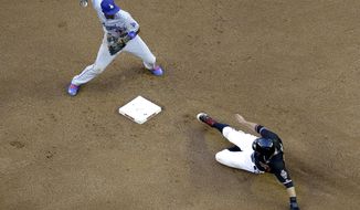 Los Angeles Dodgers&#39; Dee Gordon, left, forces out Arizona Diamondbacks&#39; Martin Prado while trying to turn a double play on Diamondbacks&#39; Alfredo Marte during the fourth inning of a baseball game on Saturday, May 17, 2014, in Phoenix. Marte was safe. (AP Photo/Matt York)