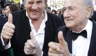 FIFA President Sepp Blatter, right, and actor Gerard Depardieu gives the thumbs up as they arrive for the screening of The Homesman at the 67th international film festival, Cannes, southern France, Sunday, May 18, 2014. (AP Photo/Thibault Camus)