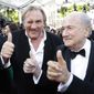 FIFA President Sepp Blatter, right, and actor Gerard Depardieu gives the thumbs up as they arrive for the screening of The Homesman at the 67th international film festival, Cannes, southern France, Sunday, May 18, 2014. (AP Photo/Thibault Camus)