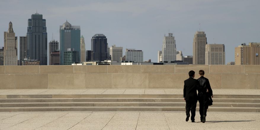 In this April 23, 2014 photo, transgender high school students Isaac Barnett, left, and his prom date, identified only by his first name Jasen, look at the Kansas City, Mo. skyline after picking up their tuxedos for prom Wednesday, April 23, 2014. The seniors, both born as females, are open about their transgender status in their schools and say friends, teachers and administrators have been much more supportive than they expected. (AP Photo/Charlie Riedel)
