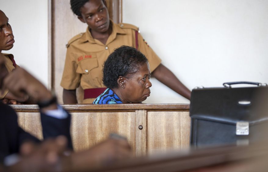 Ugandan nurse Rosemary Namubiru, who is 64 and HIV positive, listens as she is sentenced to three years in jail after being found guilty of criminal negligence for allegedly trying to infect her patient with HIV, at Buganda magistrates court in Kampala, Uganda Monday, May 19, 2014. Namubiru maintained her innocence throughout the trial, saying there was no malice involved when she accidentally pricked herself one day in January and then used the same contaminated needle to give a baby an injection, and the conviction comes despite the work of international activist groups that had rallied in support of her, but many Ugandans see her case as a shocking example of malice or negligence by a trusted medical worker. (AP Photo/Rebecca Vassie)