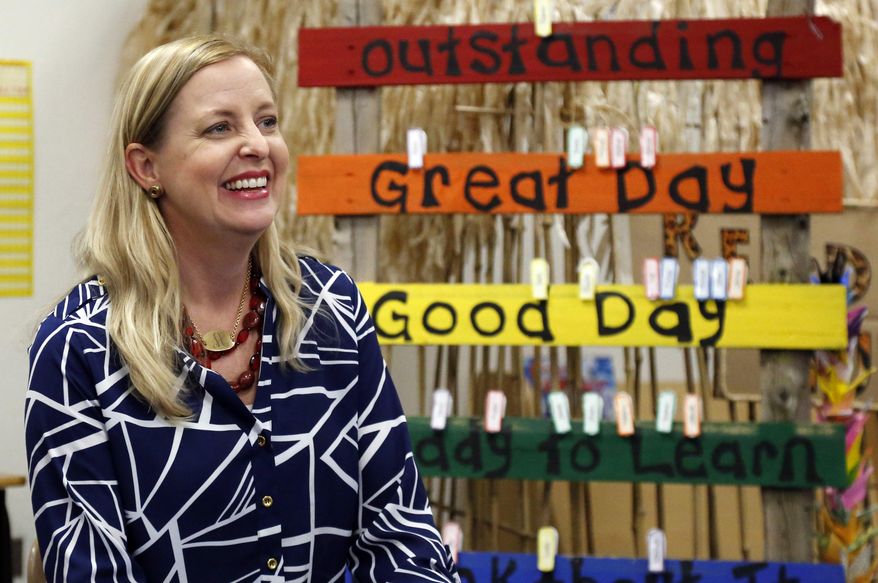 In this May 16, 2014 photo, Amy Simpson, Plaza Towers Elementary school principal, smiles during an interview in a classroom at the temporary home of the school in Moore, Okla. Simpson said that she is usually upbeat with the teachers and students, so that when they saw her being serious the day of the May 20, 2013 tornado, they knew that something was amiss. (AP Photo/Sue Ogrocki)