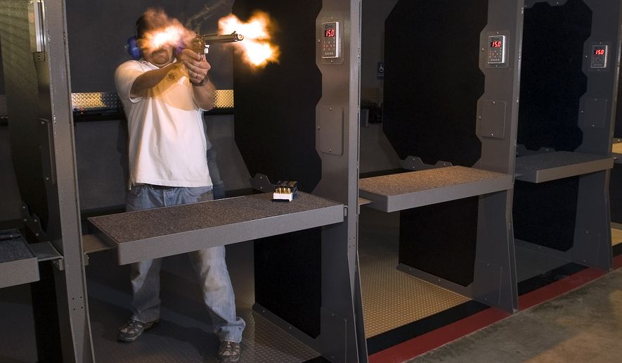 In an undated photo made with a remote camera, Field Time Target & Training operations manager Craig Caringella is obscured by the muzzle blast while firing a .500 S&W Magnum revolver at the new Stanton shooting in Stanton, Calif. The gun range can accommodate all pistols in addition to powerful rifles. (AP Photo/The Orange County Register, Jebb Harris ) MAGS OUT; LOS ANGELES TIMES OUT