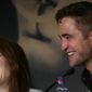 Actress Julianne Moore, left, and actor Rob Pattinson laugh during a press conference for Maps to the Stars at the 67th international film festival, Cannes, southern France, Monday, May 19, 2014. (AP Photo/Virginia Mayo)