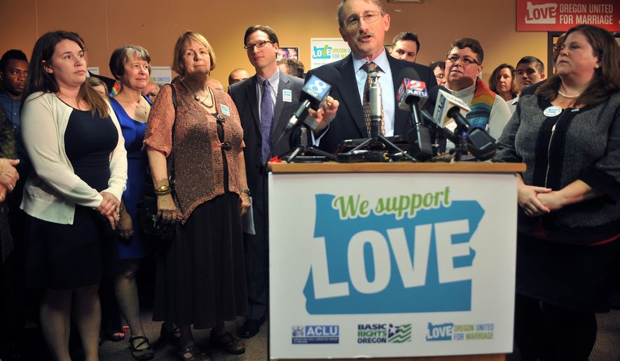 David Fidanque of the ACLU speaks to a crowd, Monday, May 19, 2014, in Portland, Ore. People gathered at the offices of Oregon United for Marriage Monday for the announcement by U.S. District Judge Michael McShane calling Oregon's ban on gay marriage unconstitutional. (AP Photo/The Oregonian, Stephanie Yao Long)