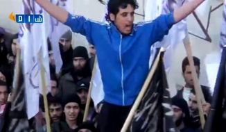 In this Feb. 13, 2014 image made from amateur video posted by Shaam News Network (SNN), an anti-Bashar Assad activist group, which has been verified and is consistent with other AP reporting, revolutionary goalkeeper Abdelbasit Sarout chants slogans during a demonstration in Homs, Syria. He began as a local hero on the soccer field, playing for the most popular team of his home city Homs and rising toward national stardom across Syria. But when the uprising against President Bashar Assad began, Sarout left all of it to lead peaceful protests, rallying thousands to demand Assad leave power. More than three years later, the former goalkeeper - now an armed fighter - has become a charismatic icon of the Syria’s rebellion. (AP Photo/Shaam News Network via AP video)