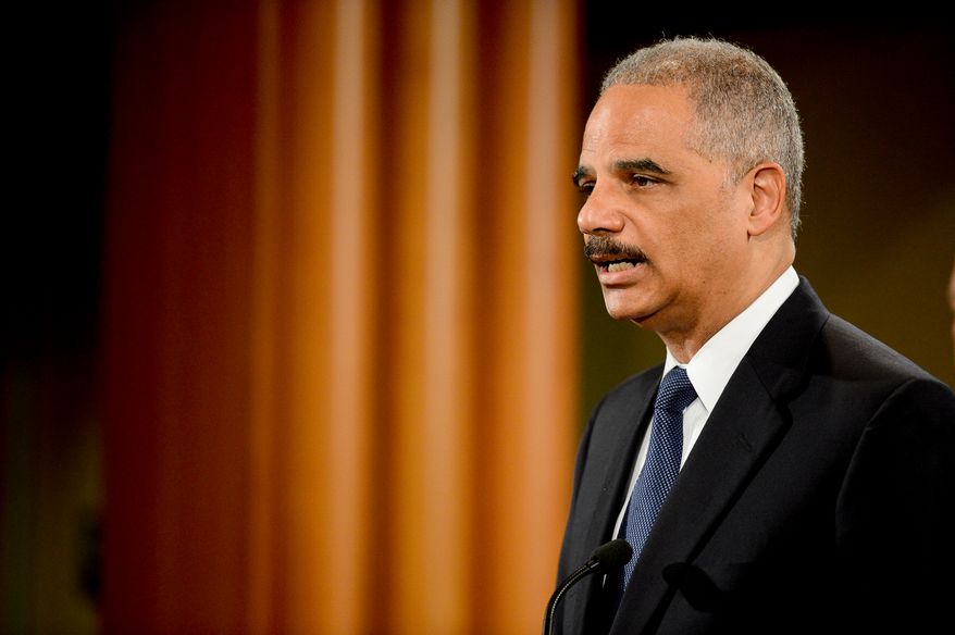 Attourney General Eric Holder announces a criminal indictment against five Chinese military hackers for cyber espionage at a press conference at the Department of Justice, Washington, D.C., Monday, May 19, 2014. The five hackers are identified as Wen Xinyu, Wang Dong, Sun Kailiang, Huang Zhenyu, and Gu Chunhui and are charged with targeting U.S. corporations and labor organizations for commercial advantage. (Andrew Harnik/The Washington Times)