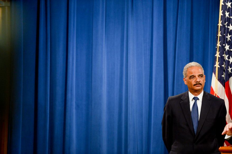 Attourney General Eric Holder announces a criminal indictment against five Chinese military hackers for cyber espionage at a press conference at the Department of Justice, Washington, D.C., Monday, May 19, 2014. The five hackers are identified as Wen Xinyu, Wang Dong, Sun Kailiang, Huang Zhenyu, and Gu Chunhui and are charged with targeting U.S. corporations and labor organizations for commercial advantage. (Andrew Harnik/The Washington Times)