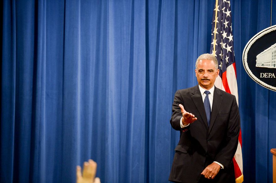 Attourney General Eric Holder announces a criminal indictment against five Chinese military hackers for cyber espionage at a press conference at the Department of Justice, Washington, D.C., Monday, May 19, 2014. The five hackers are identified as Wen Xinyu, Wang Dong, Sun Kailiang, Huang Zhenyu, and Gu Chunhui and are charged with targeting U.S. corporations and labor organizations for commercial advantage. (Andrew Harnik/The Washington Times)