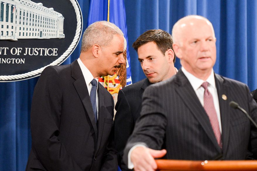 Attourney General Eric Holder, left, whispers with Assistant Attorney General for National Security John Carlin, center, as U.S. Attorney for Western District of Pennsylvania David Hickton, right, speaks during a press conference to announce a criminal indictment against five Chinese military hackers for cyber espionage at the Department of Justice, Washington, D.C., Monday, May 19, 2014. The five hackers are identified as Wen Xinyu, Wang Dong, Sun Kailiang, Huang Zhenyu, and Gu Chunhui and are charged with targeting U.S. corporations and labor organizations for commercial advantage. (Andrew Harnik/The Washington Times)