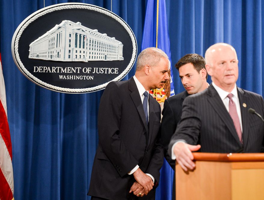 Attourney General Eric Holder, left, whispers with Assistant Attorney General for National Security John Carlin, second from right, as U.S. Attorney for Western District of Pennsylvania David Hickton, right, speaks during a press conference to announce a criminal indictment against five Chinese military hackers for cyber espionage at the Department of Justice, Washington, D.C., Monday, May 19, 2014. The five hackers are identified as Wen Xinyu, Wang Dong, Sun Kailiang, Huang Zhenyu, and Gu Chunhui and are charged with targeting U.S. corporations and labor organizations for commercial advantage. (Andrew Harnik/The Washington Times)