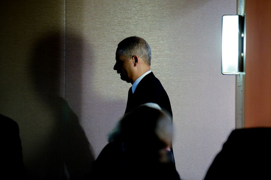 Attourney General Eric Holder leaves after announcing a criminal indictment against five Chinese military hackers for cyber espionage at a press conference at the Department of Justice, Washington, D.C., Monday, May 19, 2014. The five hackers are identified as Wen Xinyu, Wang Dong, Sun Kailiang, Huang Zhenyu, and Gu Chunhui and are charged with targeting U.S. corporations and labor organizations for commercial advantage. (Andrew Harnik/The Washington Times)