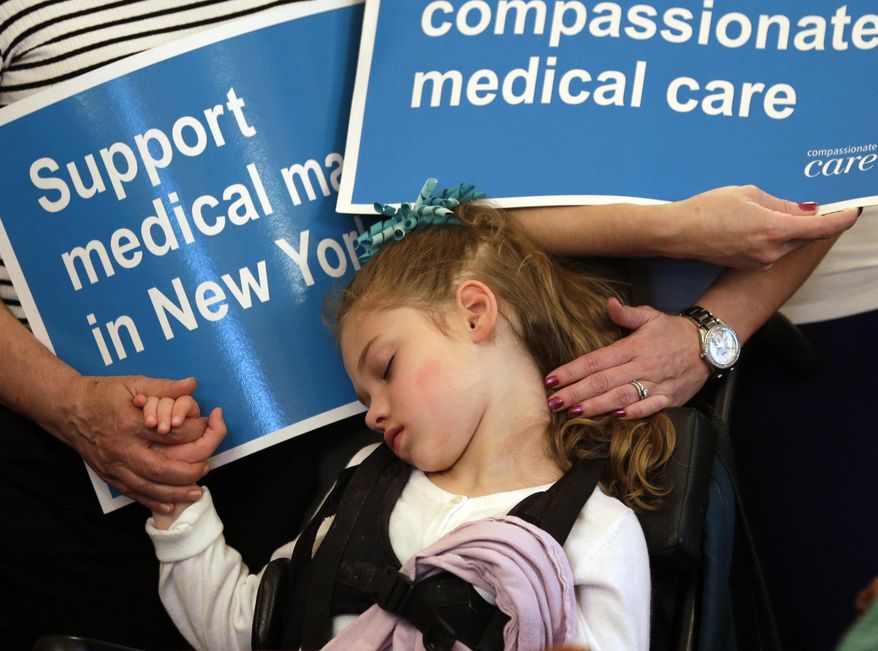 Haley Hilt, 7, of East Greenbush, N.Y., who suffers from epilepsy, is comforted by her mother Melissa and a friend during Senate health committee meeting at the Capitol on Tuesday, May 20, 2014, in Albany, N.Y. Haley suffers from epilepsy. A bill that would legalize medical marijuana in New York has passed the Republican-led health committee, one of a series of hurdles the measure will have to go through before becoming law. (AP Photo/Mike Groll)
