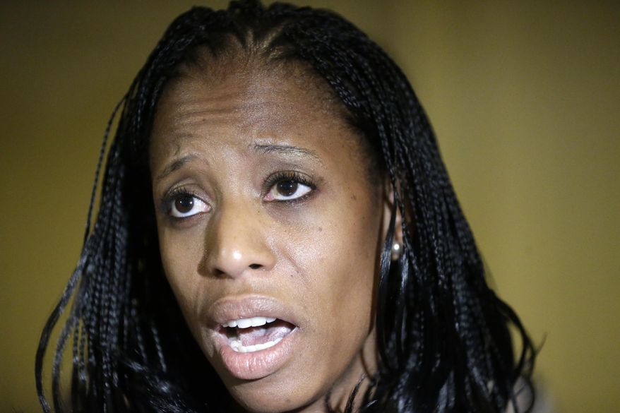 Republican Mia Love candidate for Utah's 4th Congressional District responds to questions from the media following the annual conference of the Utah Taxpayers Association, Tuesday, May 20, 2014, in Salt Lake City. In their first appearance together, Republican Love and Democrat Doug Owens fielded questions from a Utah taxpayer watchdog group. Owens used his first joint appearance with Republican Mia Love to portray her positions as extreme and hammer the front-runner candidate on her support of U.S. Sen. Mike Lee, a Utah Republican and favorite of tea party conservatives. (AP Photo/Rick Bowmer)