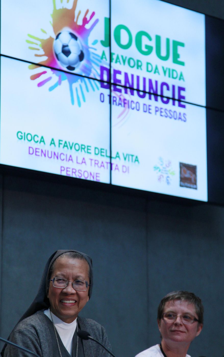 Sisters Estrella Castallone, left, and Gabriella Bottani sit in front of a screen reading: "Play in favor of life, Denounce the human trafficking"during a press conference at the Vatican, Tuesday, May 20, 2014. A global network of religious orders against human trafficking has announced a campaign during the upcoming World Cup in Brazil to draw attention to risks that the event will encourage an increase in child prostitution. Sister Gabriella Bottani, an Italian nun, said the "greatest concern is linked to the increase in the exploitation of child prostitution," but that such major international sporting events also attract human traffickers who trick people into cheap or slave labor. She noted that the risk for exploitation grew by 30 percent to 40 percent during the world cups in Germany and South Africa. As part of the campaign organized by Talitha Kum, members will hand out leaflets at airports and key tourist areas encouraging people to report suspected child prostitution or enslavement. ( AP Photo/Gregorio Borgia)