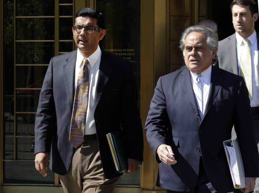 Conservative scholar and filmmaker Dinesh D'Souza, left, accompanied by his lawyer Benjamin Brafman leave federal court, in New York, Tuesday, May 20, 2014. D'Souza has pleaded guilty in New York federal court to making illegal campaign contributions. He admitted getting two close associates to make $10,000 contributions to Wendy Long. She was a candidate who lost the New York Senate race in 2012 to the Democratic incumbent. His plea agreement calls for a sentence of 10 to 16 months in prison. He'll be sentenced on Sept. 23. (AP Photo/Richard Drew)