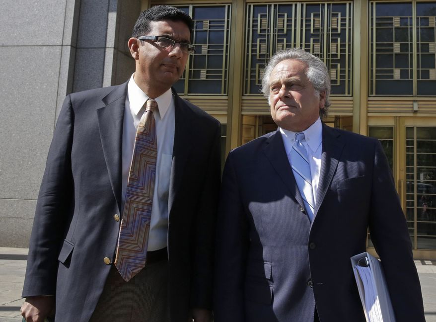 Conservative scholar and filmmaker Dinesh D'Souza, left, accompanied by his lawyer Benjamin Brafman leave federal court, in New York,  Tuesday, May 20, 2014.  D'Souza has pleaded guilty in New York federal court to making illegal campaign contributions. He admitted getting two close associates to make $10,000 contributions to Wendy Long. She was a candidate who lost the New York Senate race in 2012 to the Democratic incumbent. His plea agreement calls for a sentence of 10 to 16 months in prison. He'll be sentenced on Sept. 23. (AP Photo/Richard Drew)