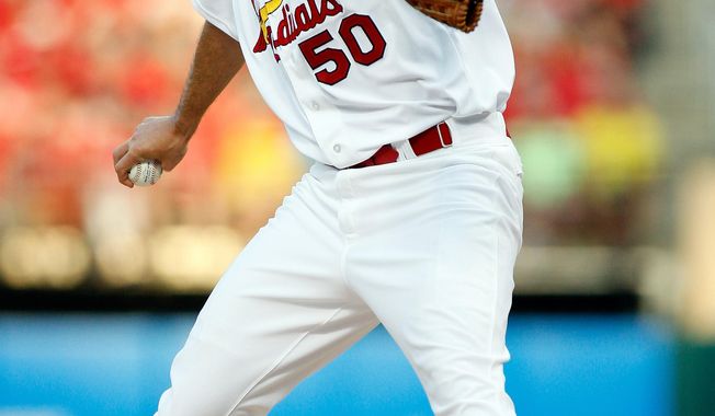 St. Louis Cardinals starting pitcher Adam Wainwright  throws during the first inning of a baseball game against the Arizona Diamondbacks Tuesday, May 20, 2014, in St. Louis. (AP Photo/Scott Kane)