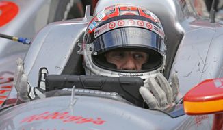 Tony Kanaan, of Brazil, talks with his crew over the radio as he sits in the car in the pit area during practice for the Indianapolis 500 IndyCar auto race at the Indianapolis Motor Speedway in Indianapolis, Monday, May 19, 2014. (AP Photo/Michael Conroy)