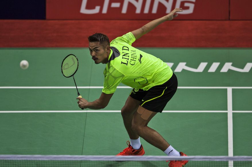 In this Tuesday, May 20, 2014 photograph, China’s Lin Dan returns a shot to Taiwan's Lin Yu Hsien during their men's singles event of the Thomas Cup Badminton in New Delhi, India. Lin Dan completed the score-line with a hard-fought 19-21, 21-13, 21-14 win. (AP Photo/Tsering Topgyal)
