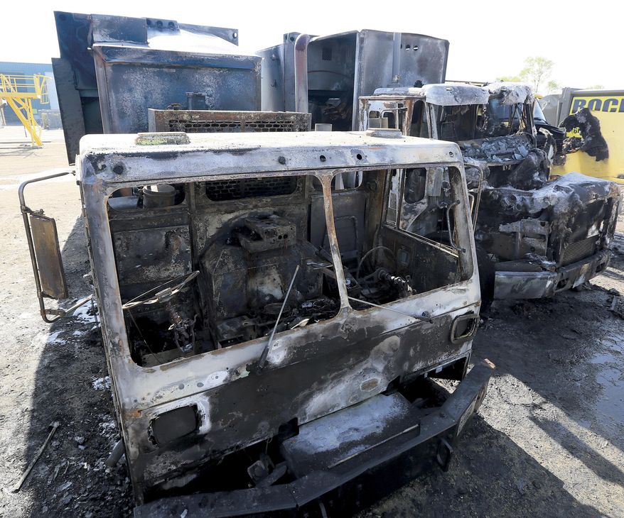 A fire Tuesday, May 20, 2014, at the Rock Disposal facility on Townline Rd. south of Janesville destroyed four garbage trucks and damaged a fifth. Fire officials say they don't suspect foul play and won't investigate further. The owner of the company says that his employees were initially told that the cause may be a lightning strike. (AP Photo/The Janesville Gazette, Bill Olmsted)