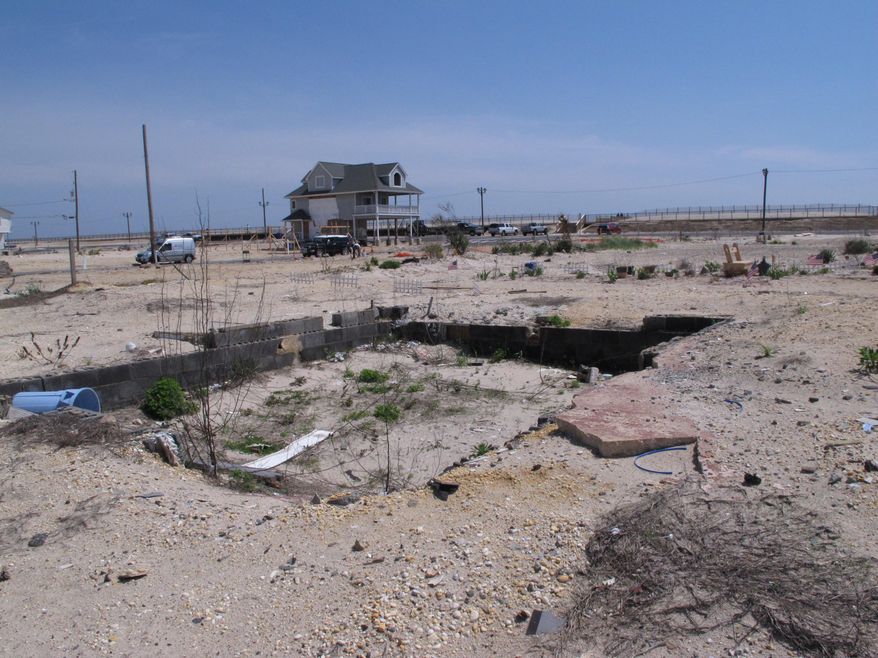 This May 12, 2014 photo shows vacant lots stretching to the oceanfront in the ortley beach section of Toms River N.J., where highly sought-after vacation and primary homes once sat before they were destroyed by Superstorm Sandy. As the second summer after the Oct. 29, 2012 storm arrives, some at the Jersey shore are getting their lives back together, while for others, getting back to normal is still a long way off.(AP Photo/Wayne Parry)