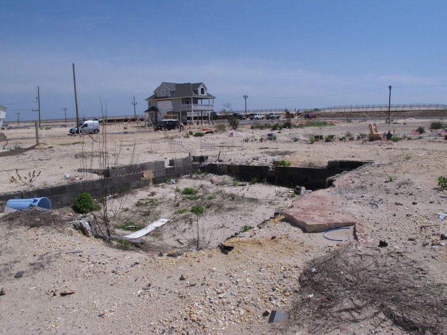 This May 12, 2014 photo shows vacant lots stretching to the oceanfront in the ortley beach section of Toms River N.J., where highly sought-after vacation and primary homes once sat before they were destroyed by Superstorm Sandy. As the second summer after the Oct. 29, 2012 storm arrives, some at the Jersey shore are getting their lives back together, while for others, getting back to normal is still a long way off.(AP Photo/Wayne Parry)