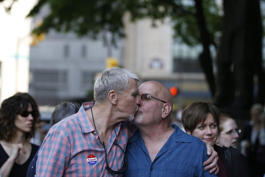 Rick Spitzborg, right, kisses his partner Blaine Bonham during a rally at City Hall, Tuesday, May 20, 2014, in Philadelphia. Pennsylvania's ban on gay marriage was overturned by a federal judge Tuesday. (AP Photo/Matt Slocum)