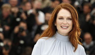 Actress Julianne Moore poses for photographers during a photo call for Maps to the Stars at the 67th international film festival, Cannes, southern France, Monday, May 19, 2014. (AP Photo/Alastair Grant)