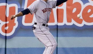 Houston Astros left fielder Jesus Guzman can&#x27;t get a glove on a double by Los Angeles Angels&#x27; Albert Pujols during the second inning of a baseball game in Anaheim, Calif., Tuesday, May 20, 2014. (AP Photo/Chris Carlson)