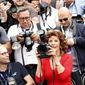 Actress Sophia Loren, front center, takes a photo as she sits with photographers during a photo call for Human Voice (Voce Umana) at the 67th international film festival, Cannes, southern France, Wednesday, May 21, 2014. (AP Photo/Alastair Grant)