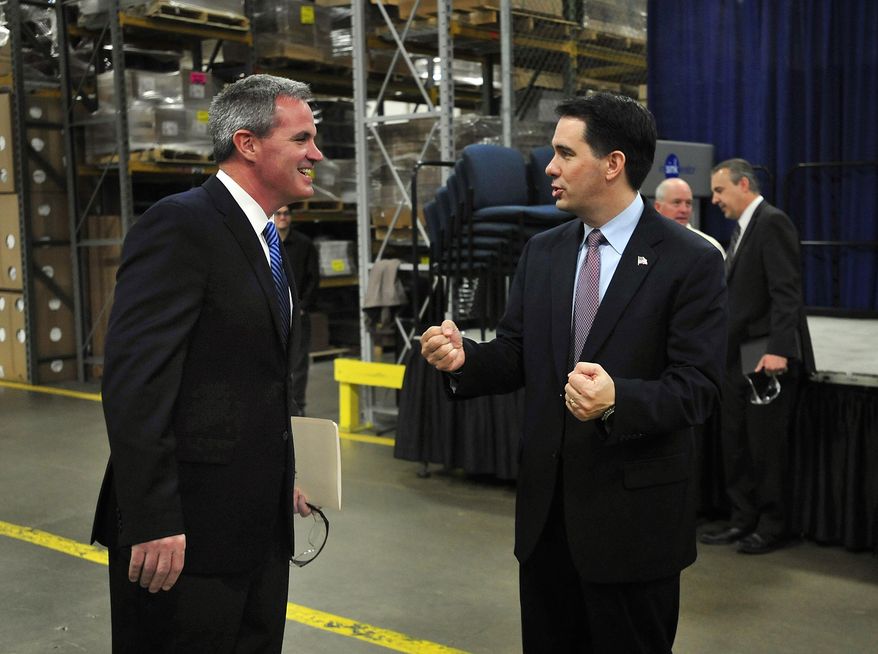 Gov. Scott Walker talks with InSinkErator president Tim Ferry on the factory floor at an event in the InSinkErator Racine plant, 4700 21st St. in Racine on Thursday morning, May 22, 2014. InSinkErator is increasing its manufacturing operations by leasing a 160,000 square-foot building in the Business Park of Kenosha and will also renovate its facility in the City of Racine in a $65 million project wthat is expected to retain 1,000 employees and add approximately 165 more jobs. The first production line in Kenosha is expected to be operational by mid-2015. The Wisconsin Economic Development Corporation has authorized up to $15.5 million in tax credits through 2018 through its Enterprise Zone program, which is designed to assist businesses that have major expansion projects or are relocating major business operations from other states. (AP Photo/Journal Times, Scott Anderson)
