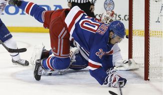 New York Rangers left wing Chris Kreider (20) flies in front of Montreal Canadiens goalie Dustin Tokarski (35) as the puck sails past the far post during the second period of Game 3 of the NHL hockey Stanley Cup playoffs Eastern Conference finals, Thursday, May 22, 2014, in New York. (AP Photo/Kathy Willens)