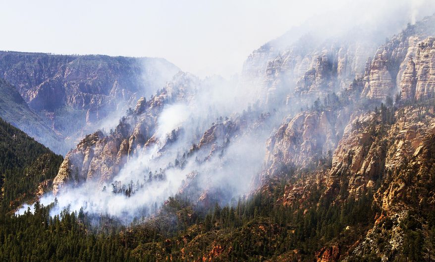 The Slide Fire burns near 89 A south of Flagstaff, Wednesday, May 21, 2014. Evacuations of surrounding areas took place late afternoon Tuesday. (AP Photo/The Arizona Republic, Tom Tingle)