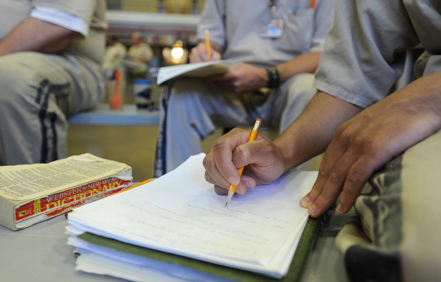 ADVANCE FOR MONDAY, MAY 26 - In this photo taken on May 6, 2014, the Writers Block, a group of inmates that meet weekly, discuss their most recent writing assignment in their cellblock at Perry Correctional Institution in Greenville, S.C. (AP Photo/The Greenville News, Heidi Heilbrunn) NO SALES