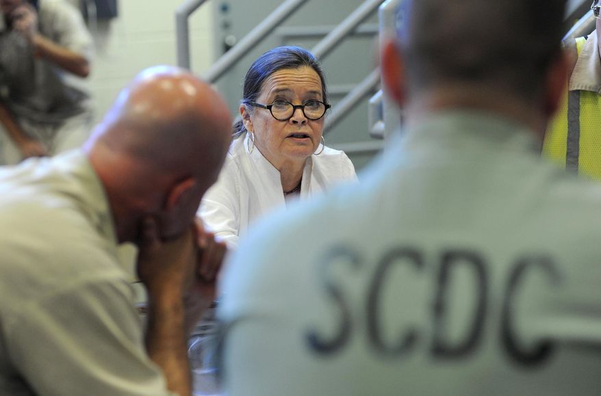 ADVANCE FOR MONDAY, MAY 26 - In this photo taken on May 6, 2014, Carol Young Gallagher, center, and Anna Katherine Freeland, not seen, lead a writing workshop called The Writers Block for a group of inmates at Perry Correctional Institution in Greenville, S.C. (AP Photo/The Greenville News, Heidi Heilbrunn) NO SALES