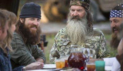 ** FILE ** This undated image released by A&amp;E shows Phil Robertson, flanked by his sons Jase Robertson, left, and Willie Robertson from the popular series &quot;Duck Dynasty.&quot; (AP Photo/A&amp;E, Zach Dilgard)
