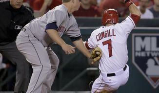 Houston Astros third baseman Matt Dominguez tags Los Angeles Angels&#x27; Collin Cowgill at third base as Cowgill tried to advance on a single by Howie Kendrick during the fifth inning of a baseball game in Anaheim, Calif., Wednesday, May 21, 2014. (AP Photo/Chris Carlson)