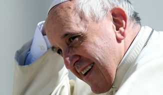 Pope Francis holds his skull cap as he arrives in St. Peter&#39;s Square for the weekly general audience, at the Vatican, Wednesday, May 14, 2014. (AP Photo/Gregorio Borgia)