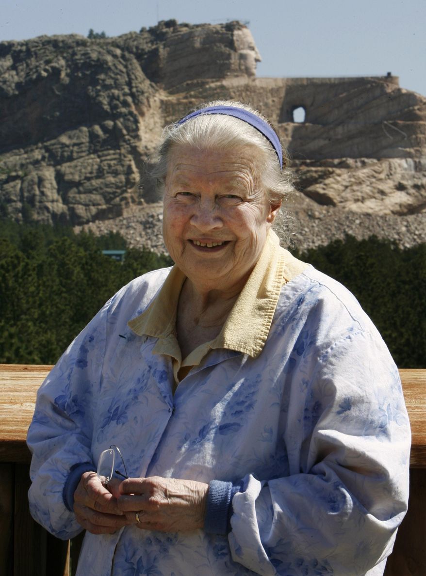 FILE - In this June 13, 2006 file photo, Ruth Ziolkowski, widow of sculptor Korczak Ziolkowski who began carving the likeness of Sioux warrior Crazy Horse into a granite mountain in 1948, stands in front of the ongoing project at Crazy Horse Memorial in the Black Hills near Custer, S.D. Ruth, who took over the dream of her husband, upon his death in 1982 and turned it into a multimillion-dollar operation that draws more than a million visitors a year, died Wednesday May 21, 2014 at age 87 according to a spokesman. (AP Photo/M. Spencer Green, File)
