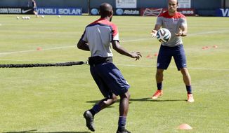 United States&#39; Landon Donovan, right, and DaMarcus Beasley take part in drills during training in preparation for the World Cup soccer tournament on Wednesday, May 21, 2014, in Stanford, Calif. (AP Photo/Marcio Jose Sanchez)