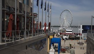 This photo taken May 20, 2014 shows the new &amp;quot;Capital Wheel&amp;quot; at National Harbor in Oxon Hill, Md. With a massive new Ferris wheel overlooking the nation’s capital, a children’s museum, a village of restaurants and hotels and a major casino resort on the horizon, National Harbor in Maryland has quickly become a travel alternative to the marble monuments and museums of nearby Washington. (AP Photo/ Evan Vucci) **FILE**