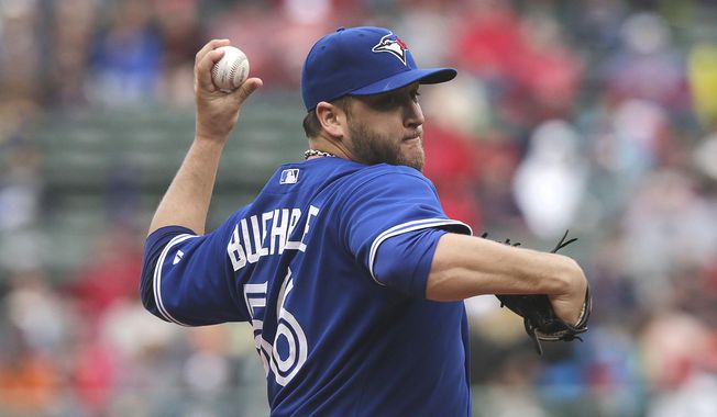 Toronto Blue Jays starting pitcher Mark Buehrle delivers to the Boston Red Sox during the first inning of a baseball game at Fenway Park, Thursday, May 22, 2014, in Boston. (AP Photo/Charles Krupa)