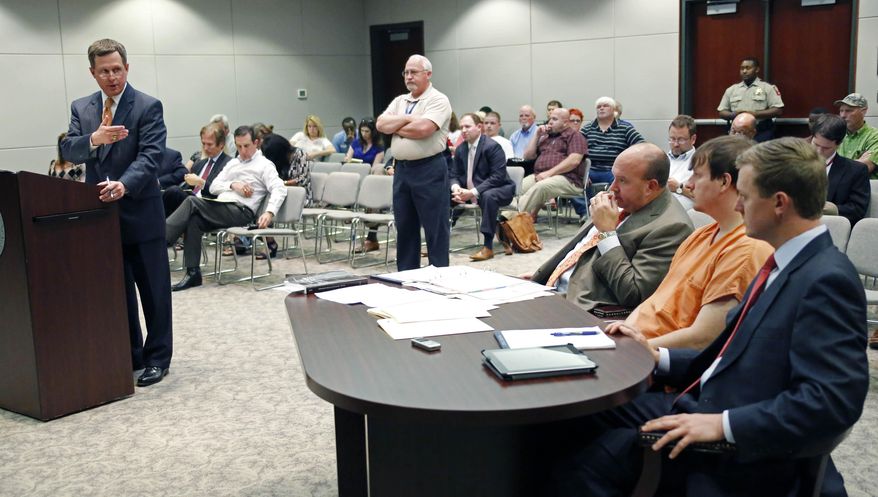City prosecutor Trae Sims, left, presents evidence during a hearing in Madison, Miss., for conservative blogger Clayton Thomas Kelly, 28 of Pearl, second from right, Thursday, May 22, 2014, on allegations that he took photos of Rose Cochran, the ailing wife of U.S. Sen. Thad Cochran, R-Miss., without her permission at the nursing home where she's lived for 13 years. Kelly is charged with exploitation, filming without permission and conspiracy. At his side are attorneys' Jared Tomlinson, right, and Kevin Camp, third from right. (AP Photo/Rogelio V. Solis)