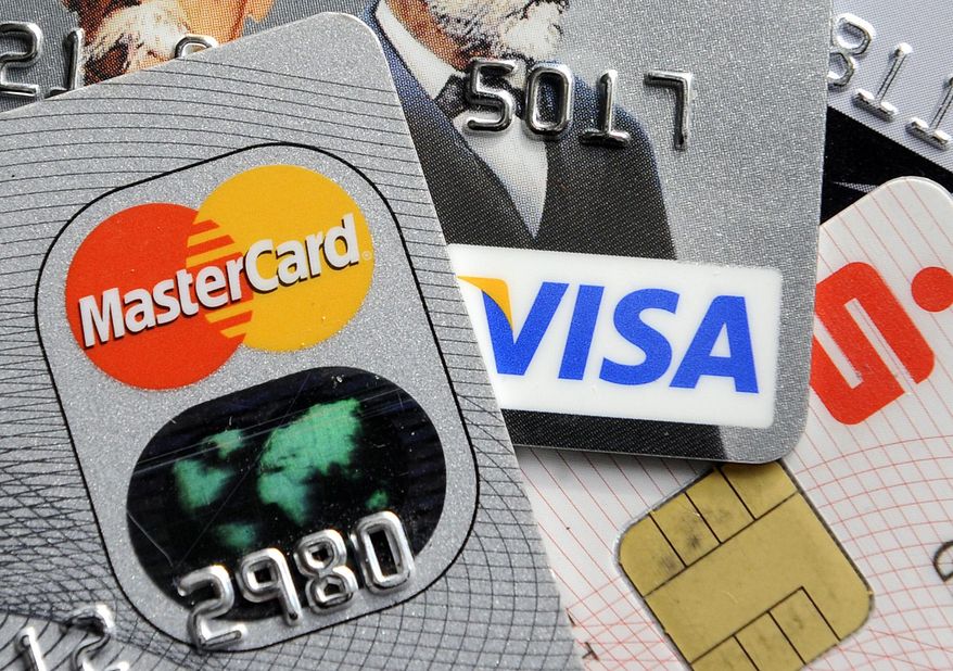 Visa and MasterCard are renewing a push to speed the adoption of microchips into U.S. credit and debit cards. (AP Photo/Martin Meissner, File)