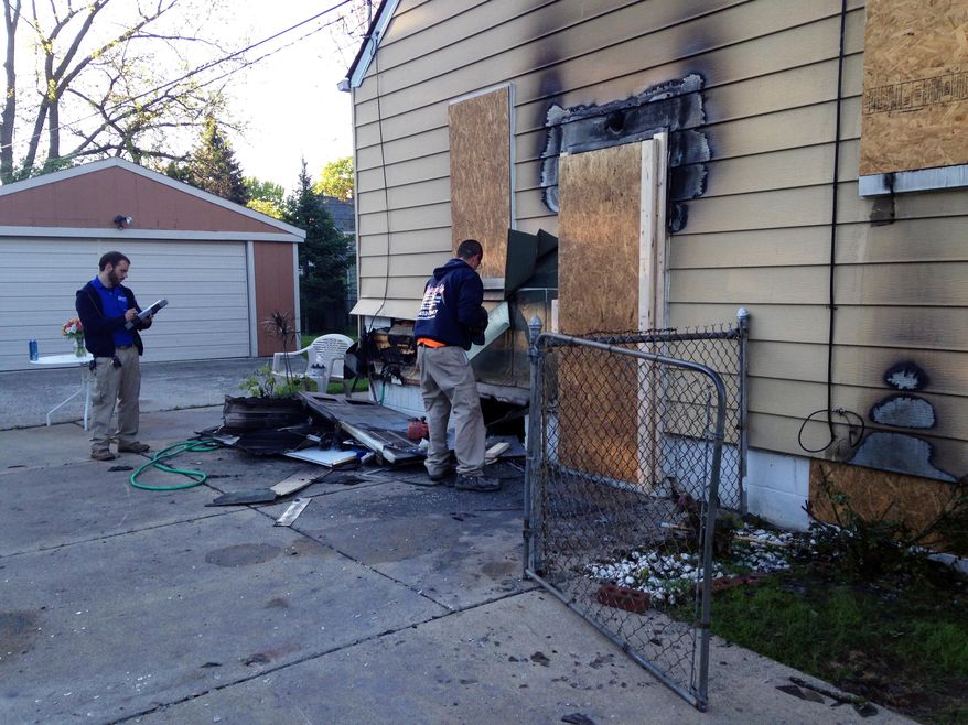 Authorities gather at the scene of a house fire under investigation on North Altadena Avenue in Royal Oak on Friday, May 23, 2014. The fire that left one person dead early this morning is under investigation, officials said. (AP Photo/Detroit Free Press, Robert Allen)