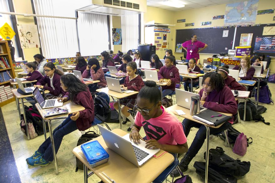 FOR RELEASE MONDAY, MAY 26, 2014, AT 12:01 A.M. CDT. -This photo taken May 6, 2014, shows sixth-grader Camaya Ezeike working in her classroom at Young Women's College Preparatory Academy in Houston. The all girls school opened in 2011 with 6th and 9th grades and will graduate its first class in 2015. "I feel more comfortable than when I went to a coed school," Ezeike said. "There's not a lot of stress." (AP Photo/Houston Chronicle, Cody Duty)