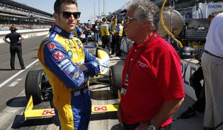 Marco Andretti, left, talks with his grandfather and 1969 Indy 500 champion Mario Andretti before the start of the final day of practice for the Indianapolis 500 IndyCar auto race at the Indianapolis Motor Speedway in Indianapolis, Friday, May 23, 2014. The 98th running of the Indianapolis 500 is Sunday. (AP Photo/Tom Strattman)
